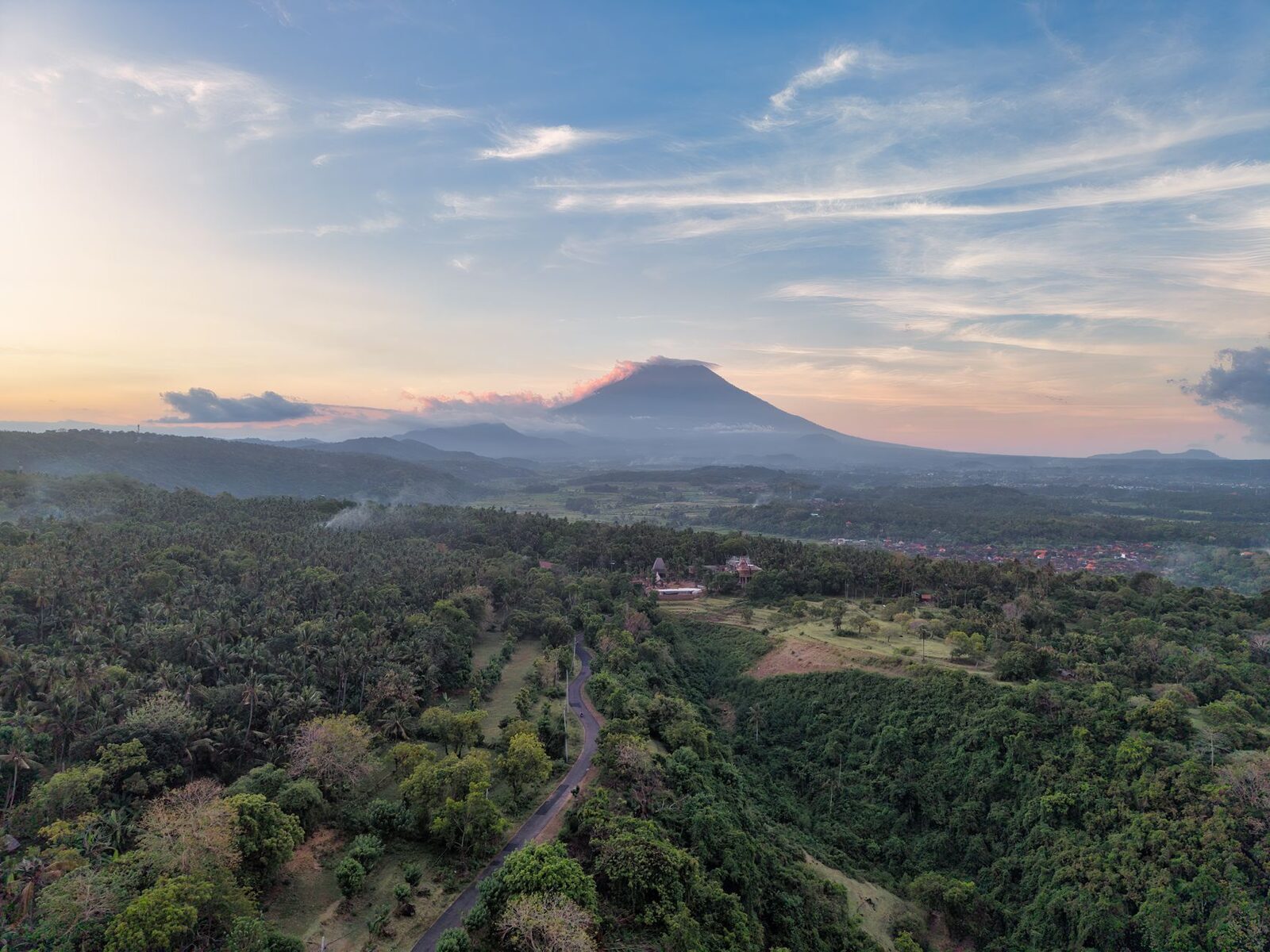 First light from the air, Agung on the horizon beyond the hills.