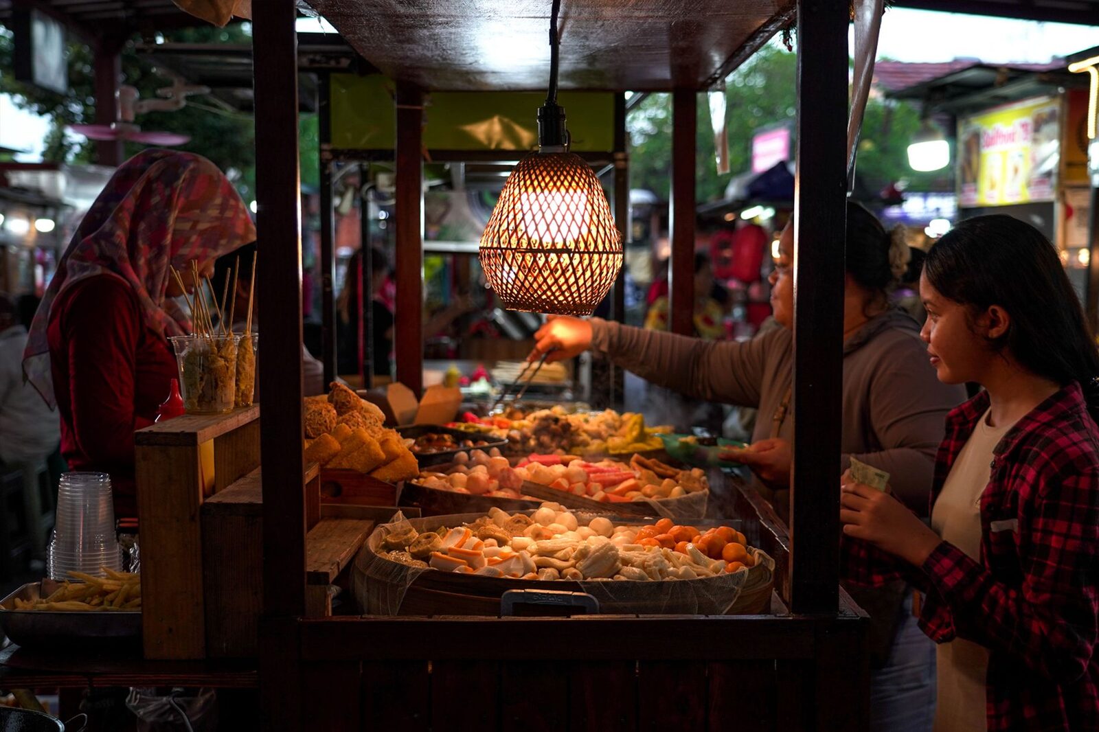 A packed night food stall with a queue — a warung this busy is a good sign, not a risk.