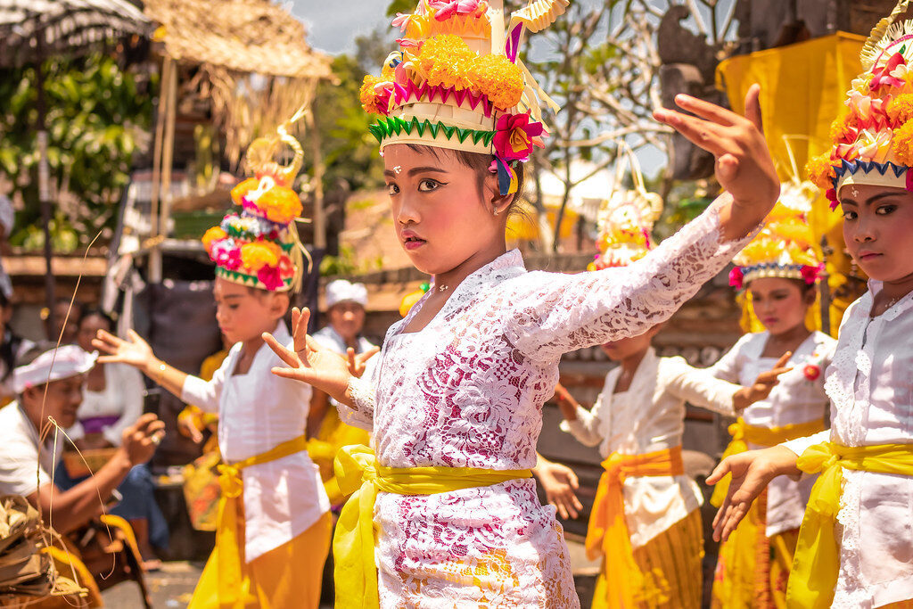 Dancers in gilt crowns and ceremonial dress — the movement that accompanies almost every temple odalan.