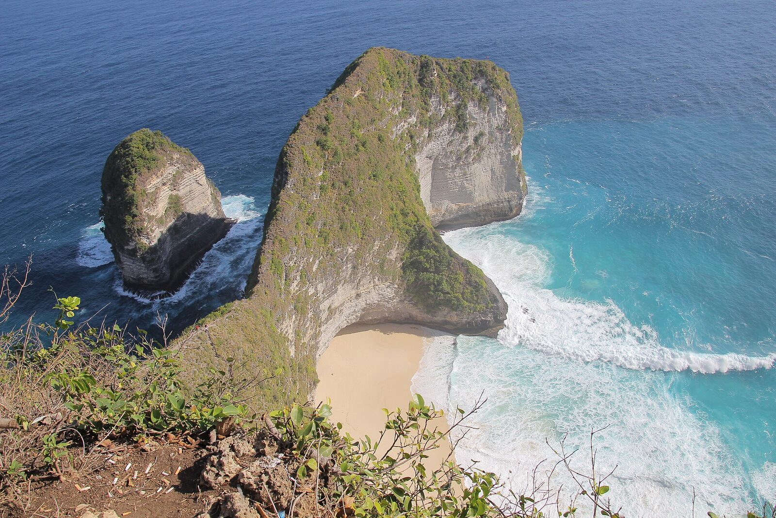 Nusa Penida's Kelingking cliff — the T-Rex headland and its turquoise cove far below. The raw island leg is the 'wow' a week adds; give it two nights, not a rushed day trip from the mainland.