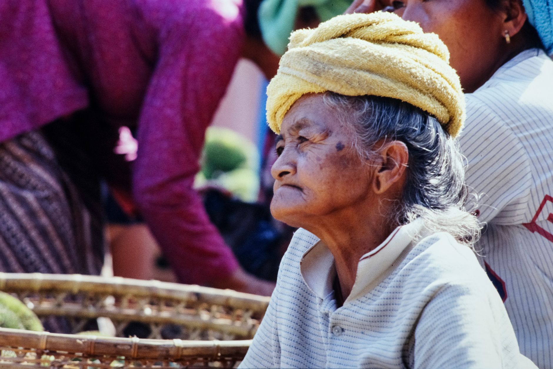 A Balinese market vendor in a headwrap