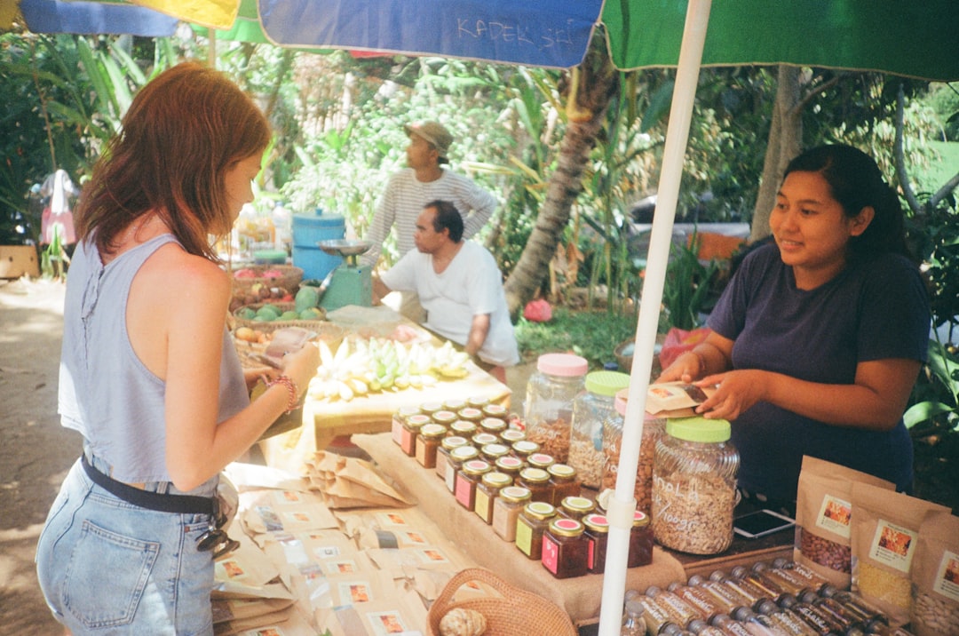 A traveller buying from a Balinese market vendor