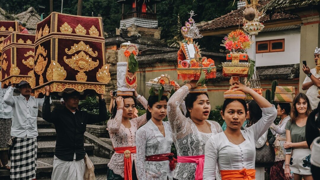 Women carry towering offerings in a Balinese temple procession.