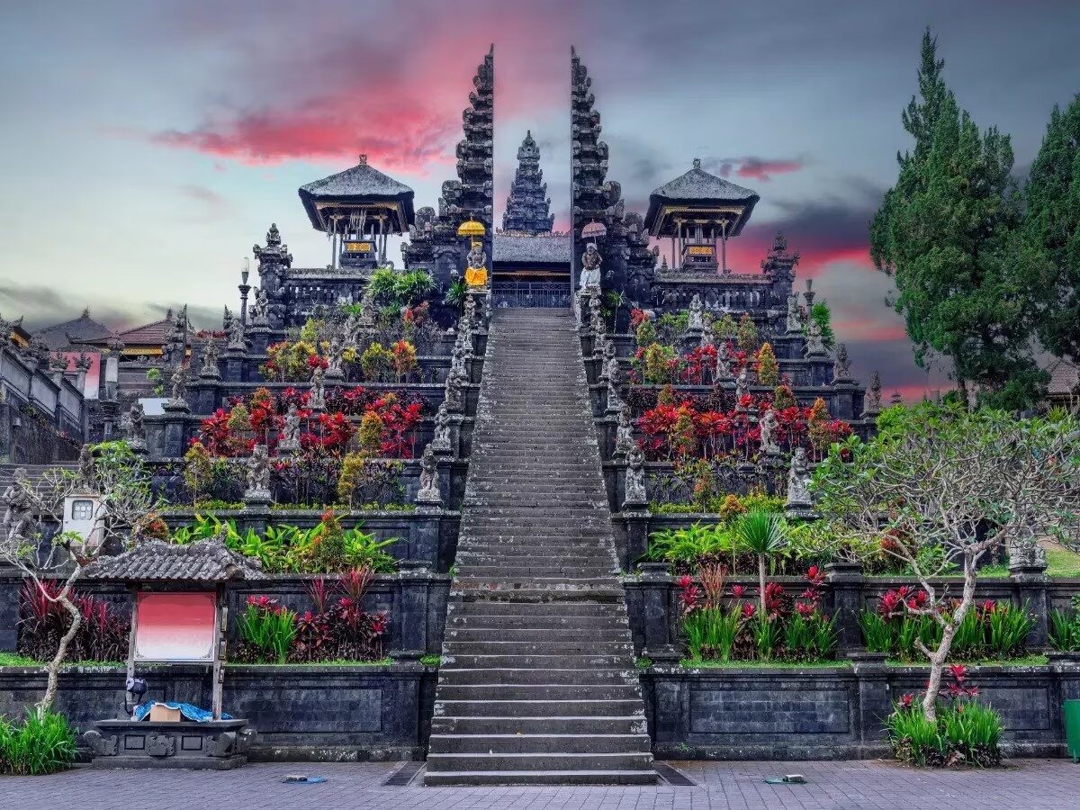 The great ceremonial stairway rising through the split gates toward Pura Penataran Agung.
