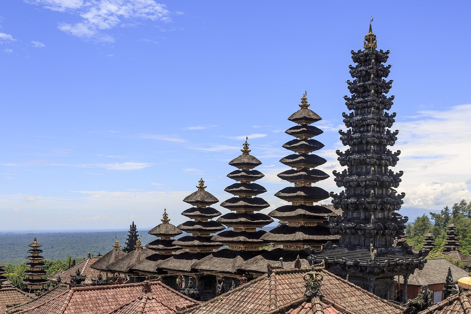 Meru roofs and tiled pavilions packed across the terraces.