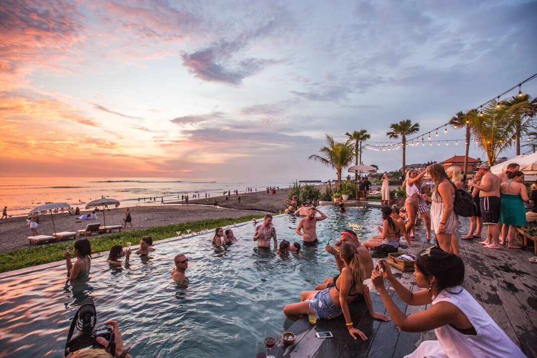 A beach club at sunset filled shoulder-to-shoulder — high-season Bali, paid for and shared.