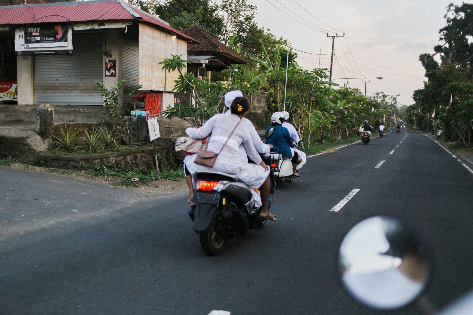 Two-up on a scooter — for many the only practical way around the Bukit's hills, if you're confident riding.