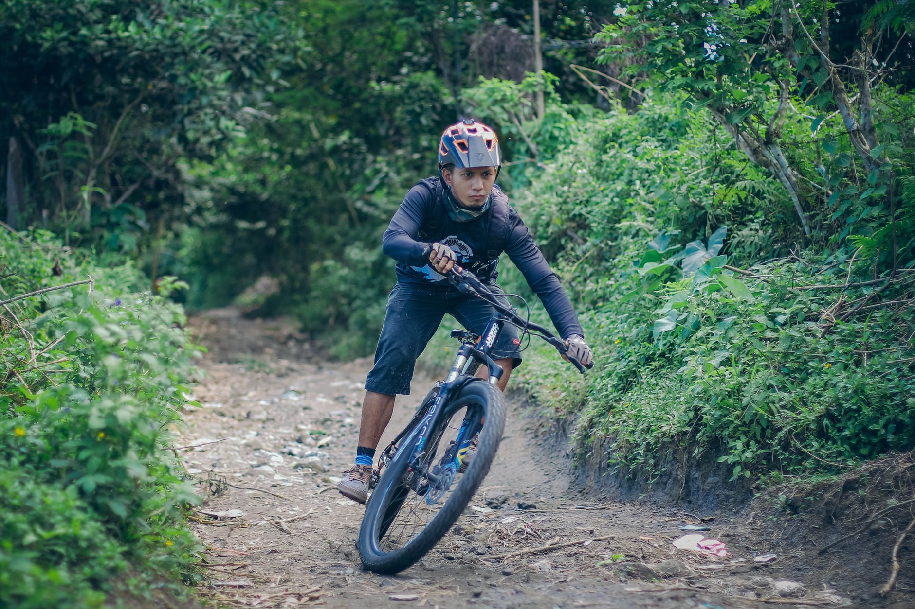 A rider tackling an off-road forest singletrack