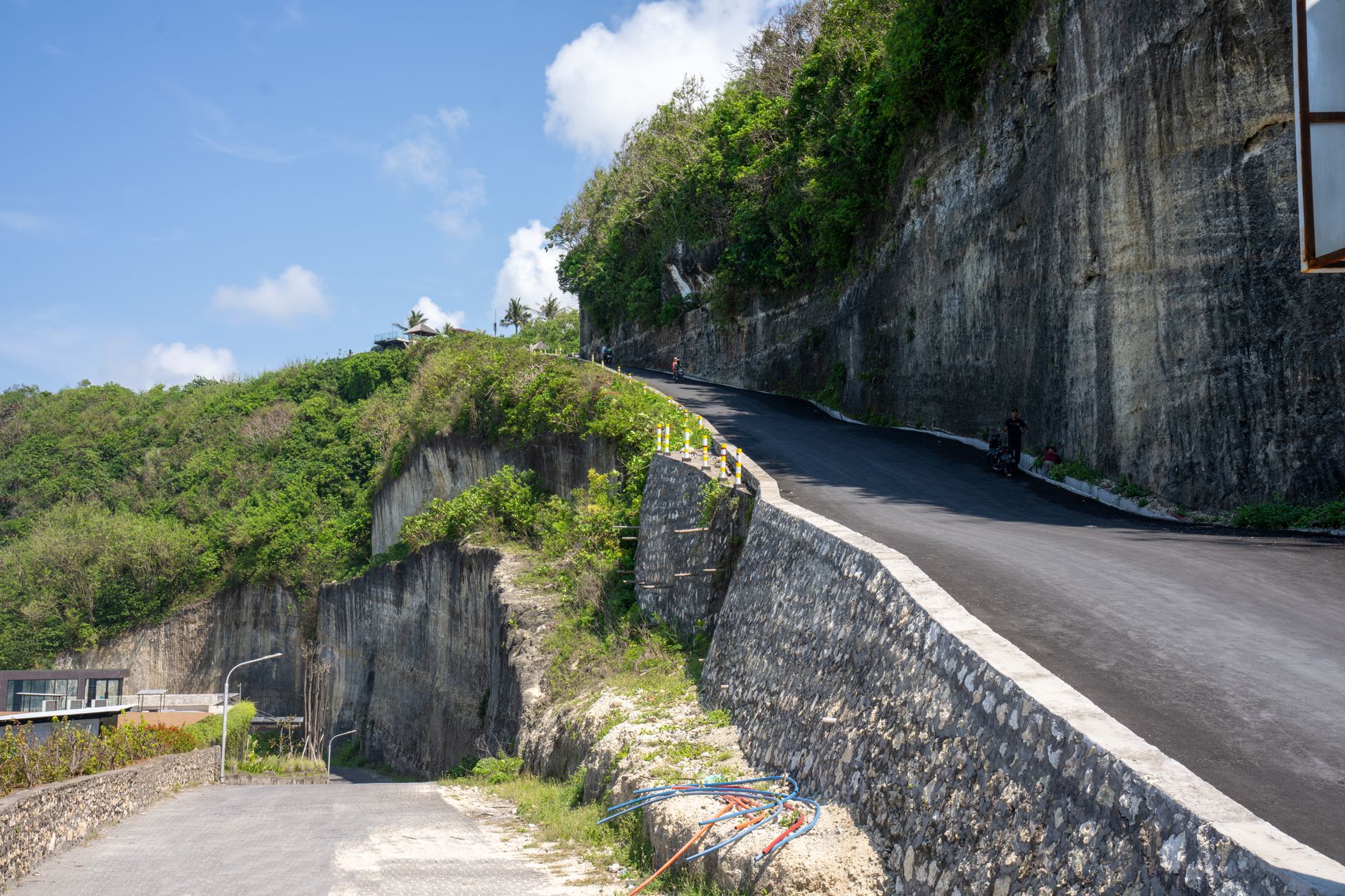 A road winding along lush cliffs in the Bali highlands