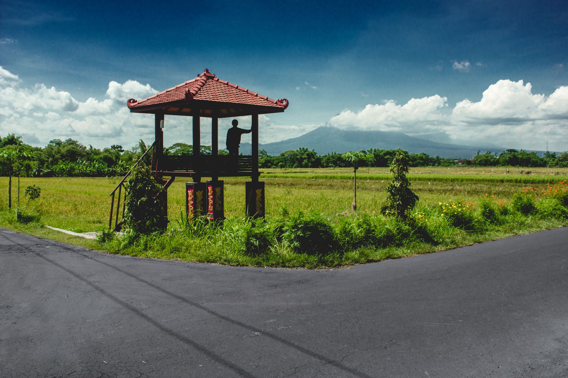 A gazebo overlooking fields and mountains on a highland road