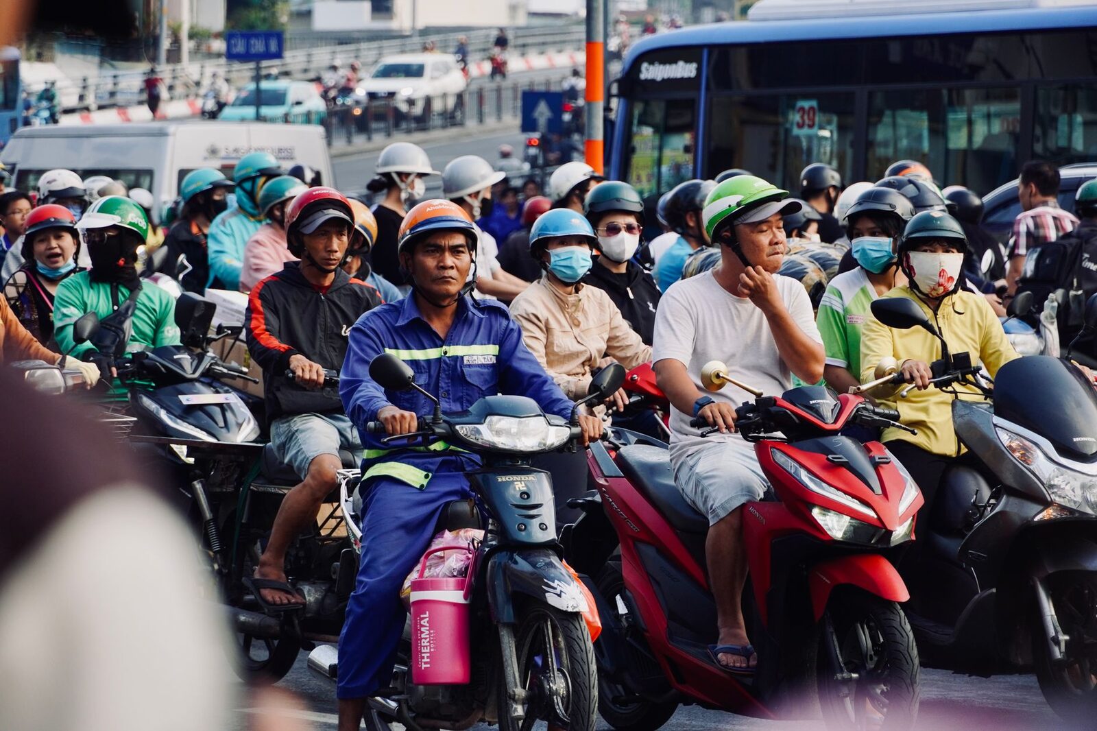 Scooters packed shoulder to shoulder at a junction — the gridlock a map will never admit to, where 20 kilometres can eat 90 minutes.