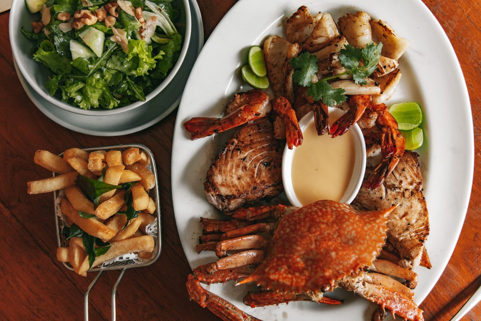 A seafood platter — crab, prawns and sides — of the kind the beach warungs plate up.