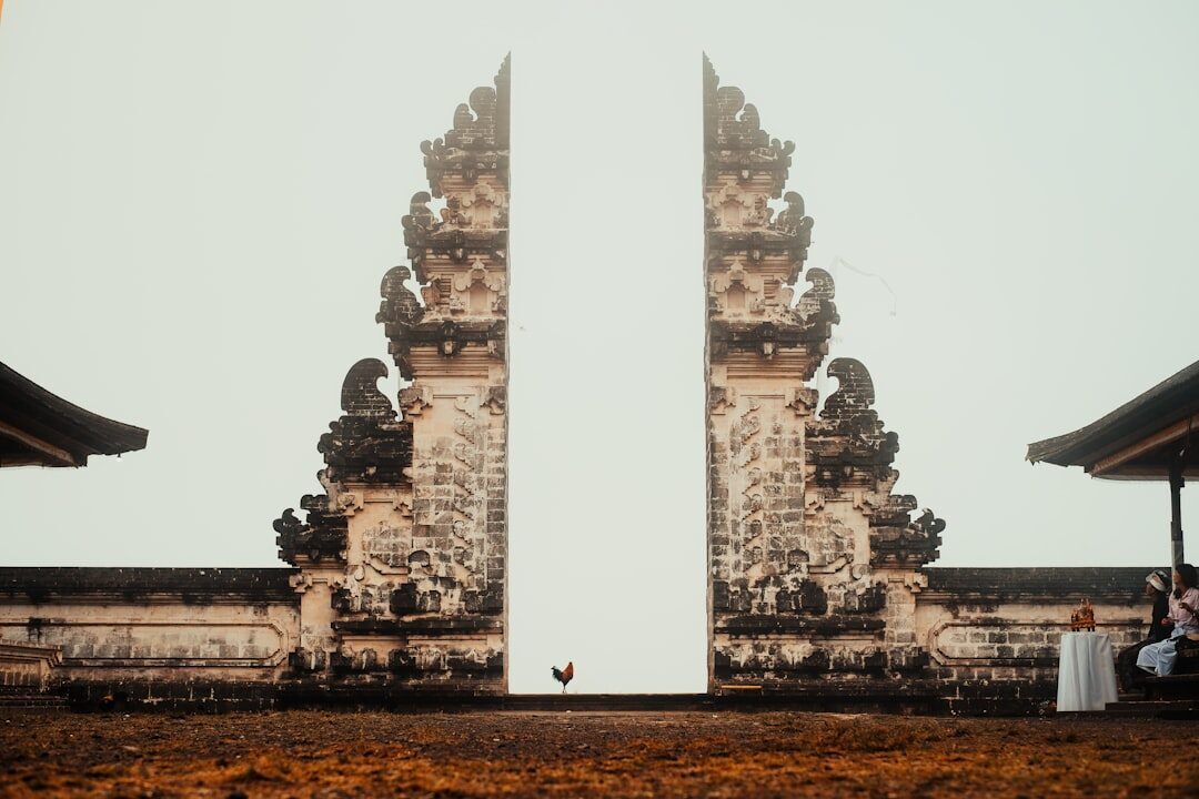 The gate seen from the plaza — cover your shoulders and don't climb on the shrines.