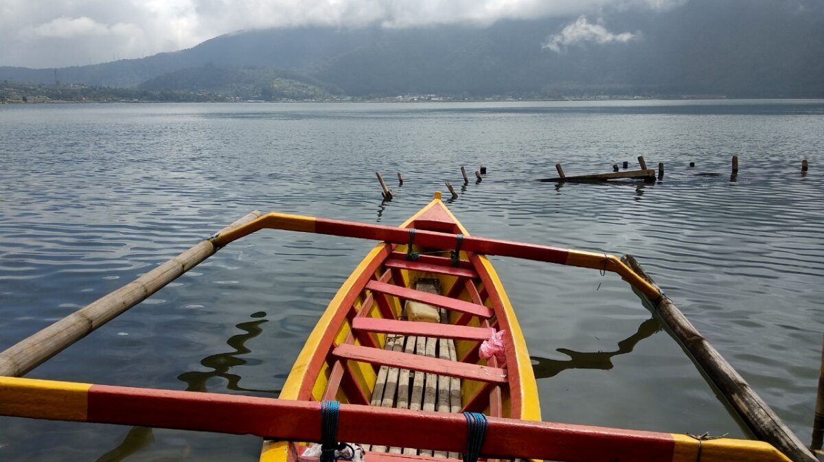 An outrigger's-eye view across a still highland crater lake near Bedugul.