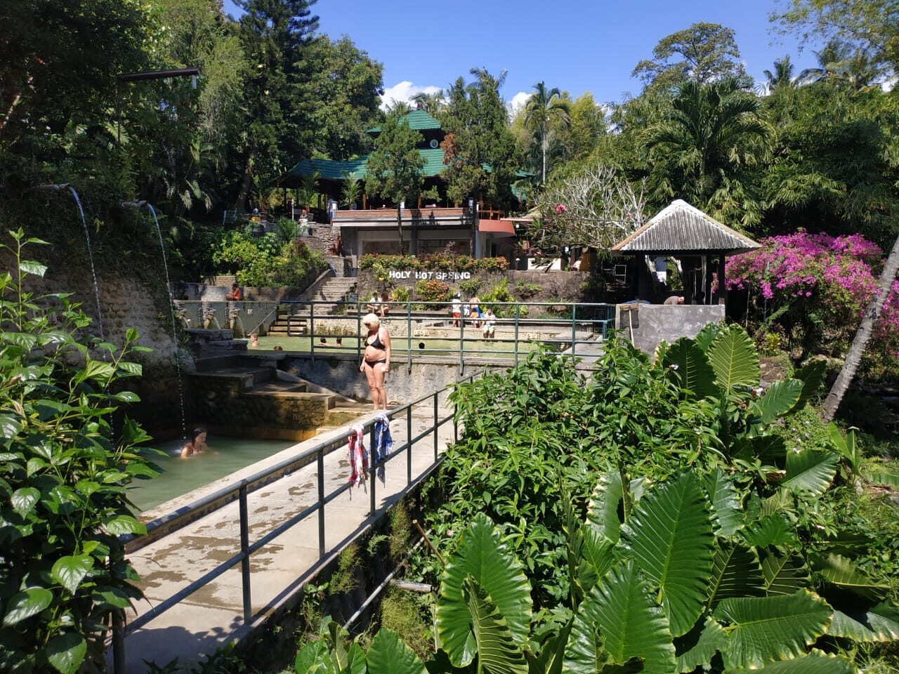 The garden setting of the Banjar hot springs — pools, a footbridge and jungle, a few minutes' walk from the road.