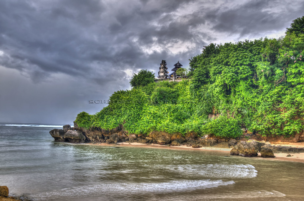 The green headland and white-sand cove below Pura Geger