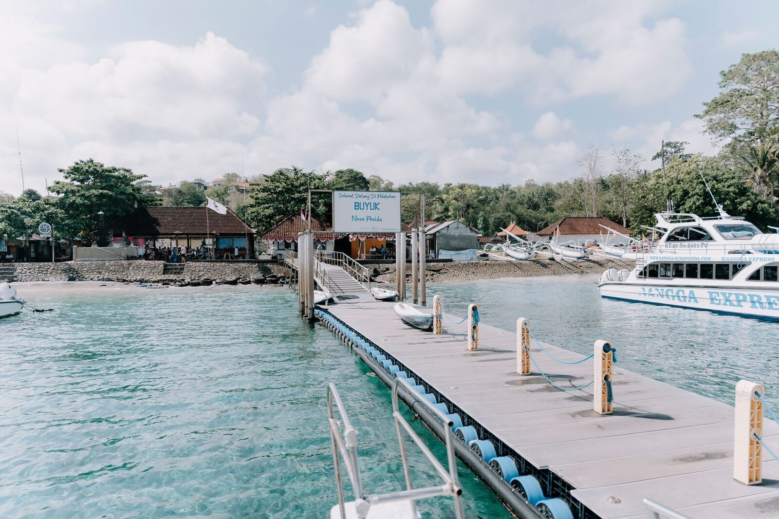 Arriving at a Nusa pier — the calmer end of the trip once the strait is behind you.