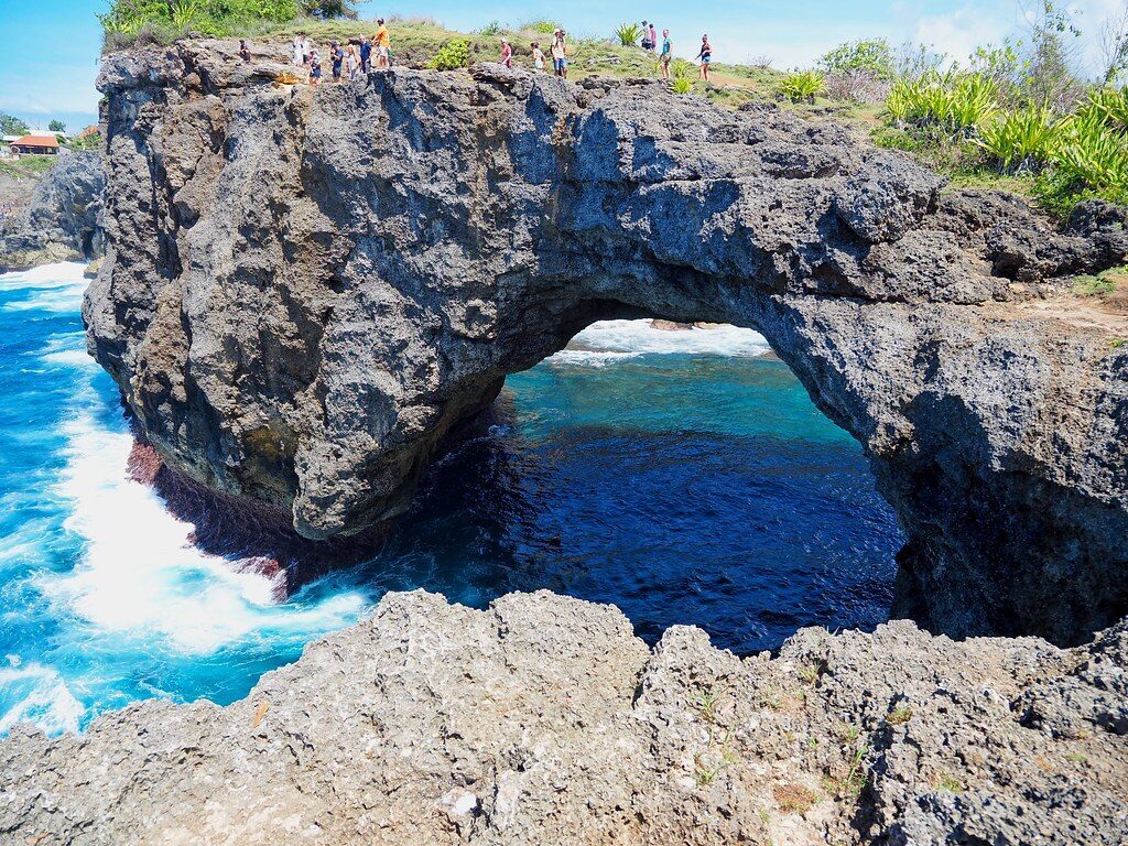 Broken Beach (Pasih Uug) nearby on Penida — a circular cliff arch enclosing a lagoon.