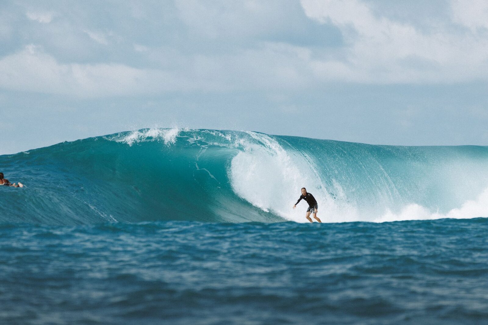 Dropping into a big, clean reef wave off the Bukit.