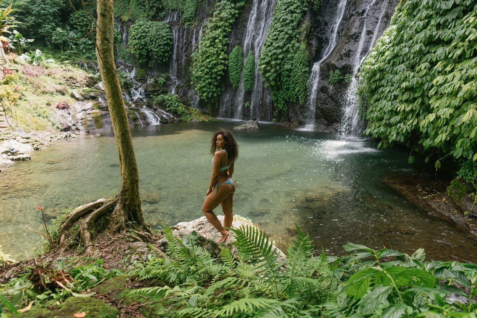 A wide fan of cascades over a mossy wall in the same waterfall country — doubling up roughly doubles the leg work.
