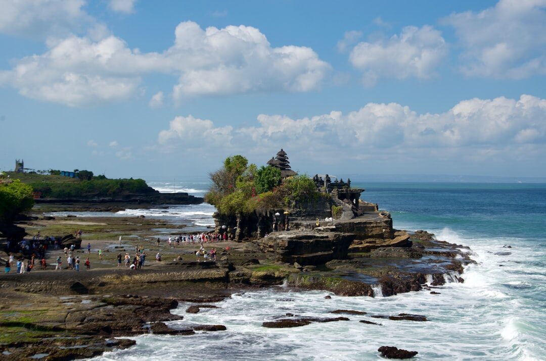 Crowds strung along the rocks at the temple's base.