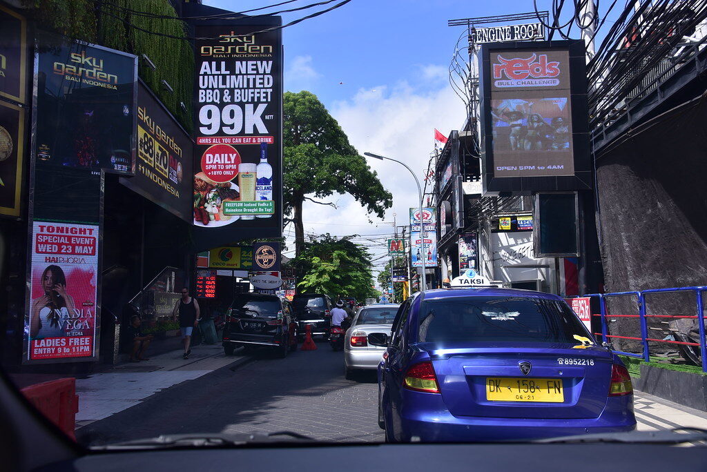 The commercialised approach — billboards and traffic on the road out to the temple.