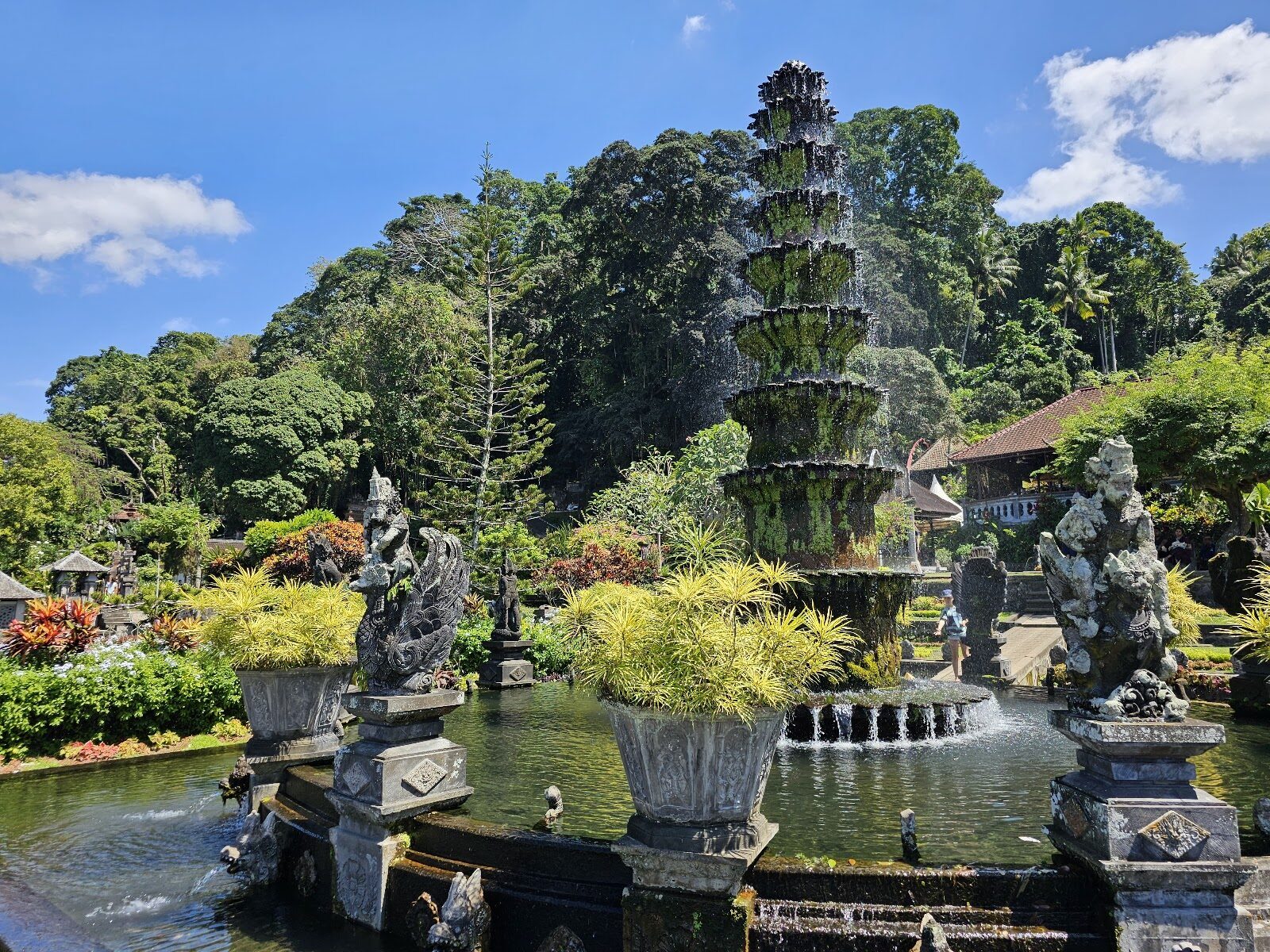 The tiered Nawa Sanga fountain against a blue sky, statues around its base.