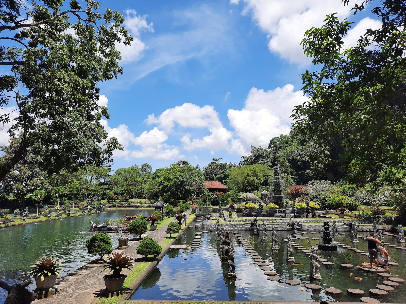 The pond, its stepping stones and rows of statues.