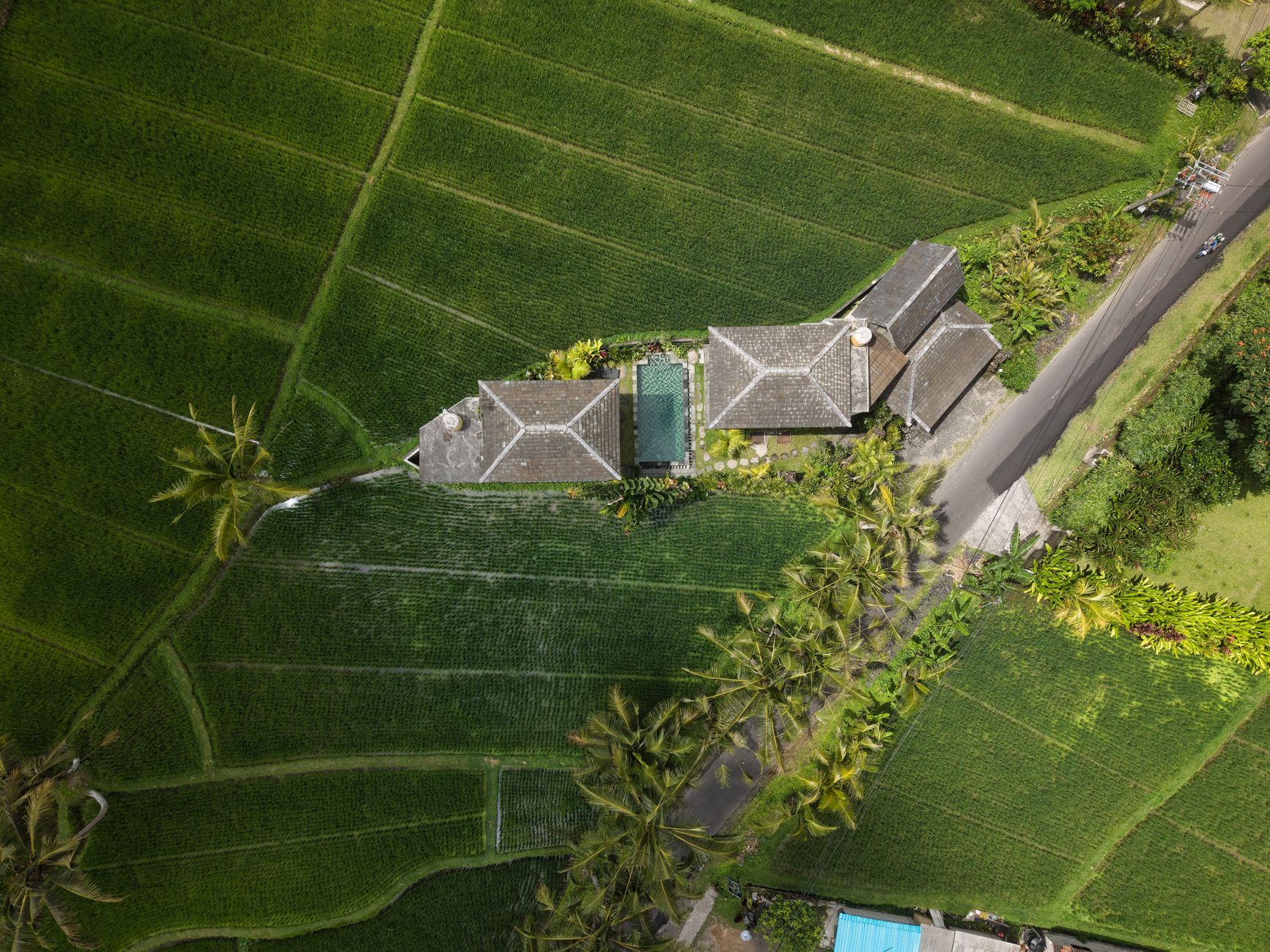 An aerial view of a villa surrounded by fields