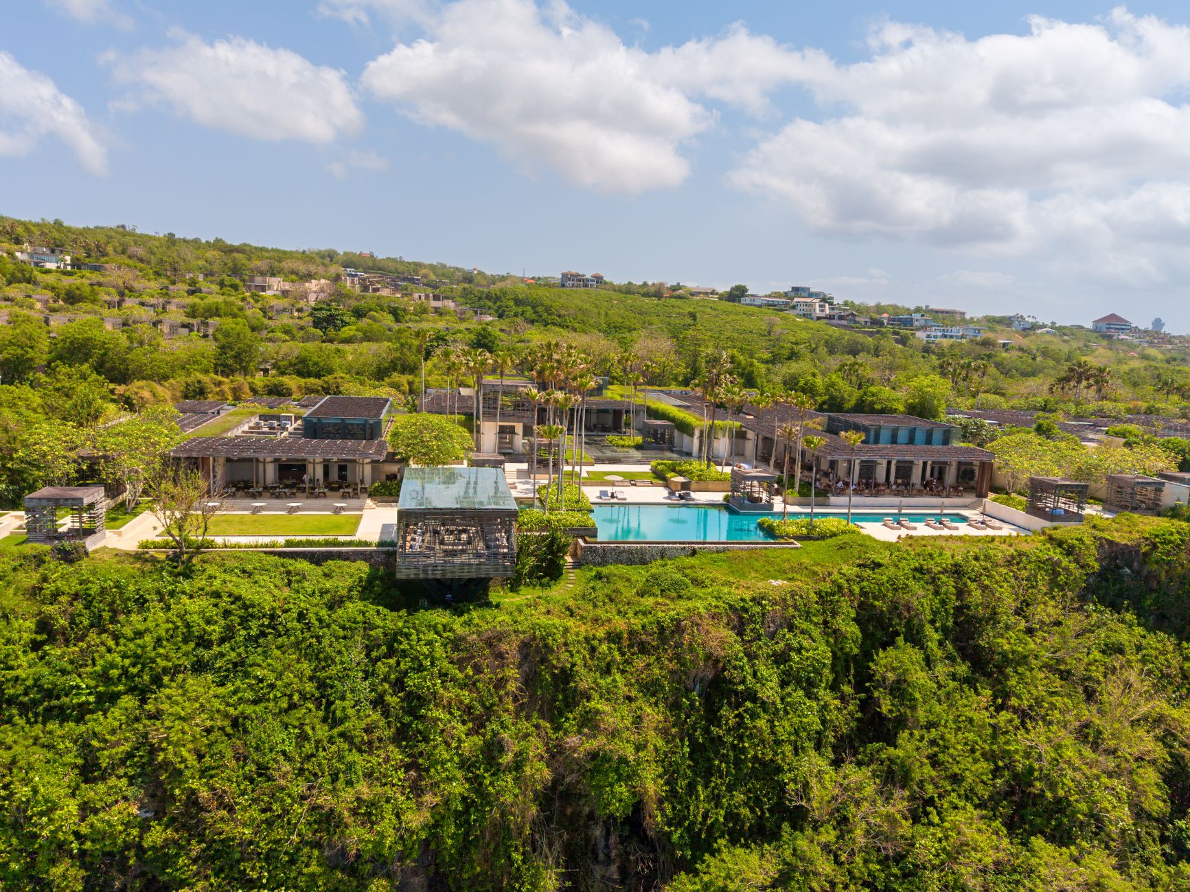 An aerial view of a villa with an infinity pool