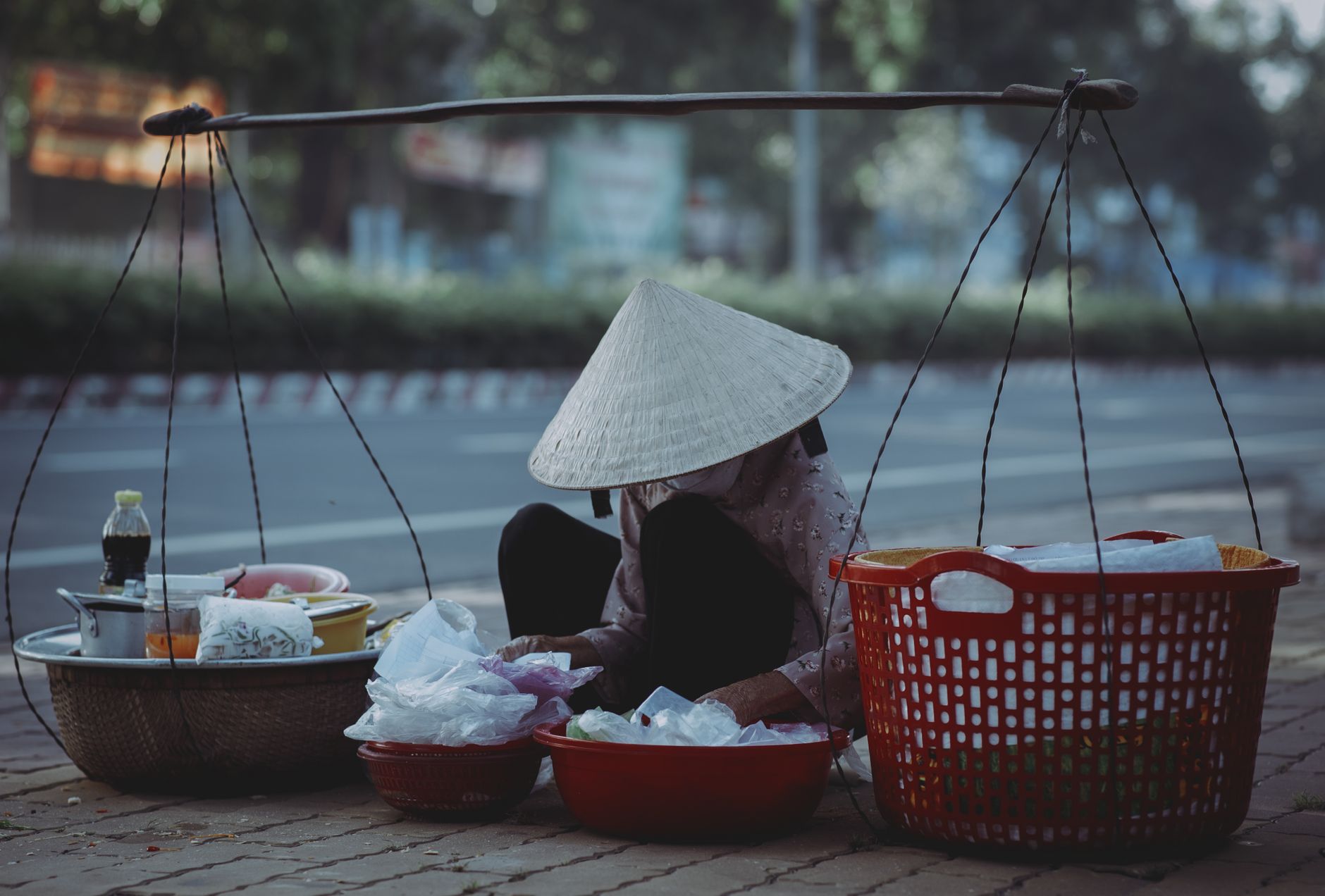 A street vendor in a conical hat