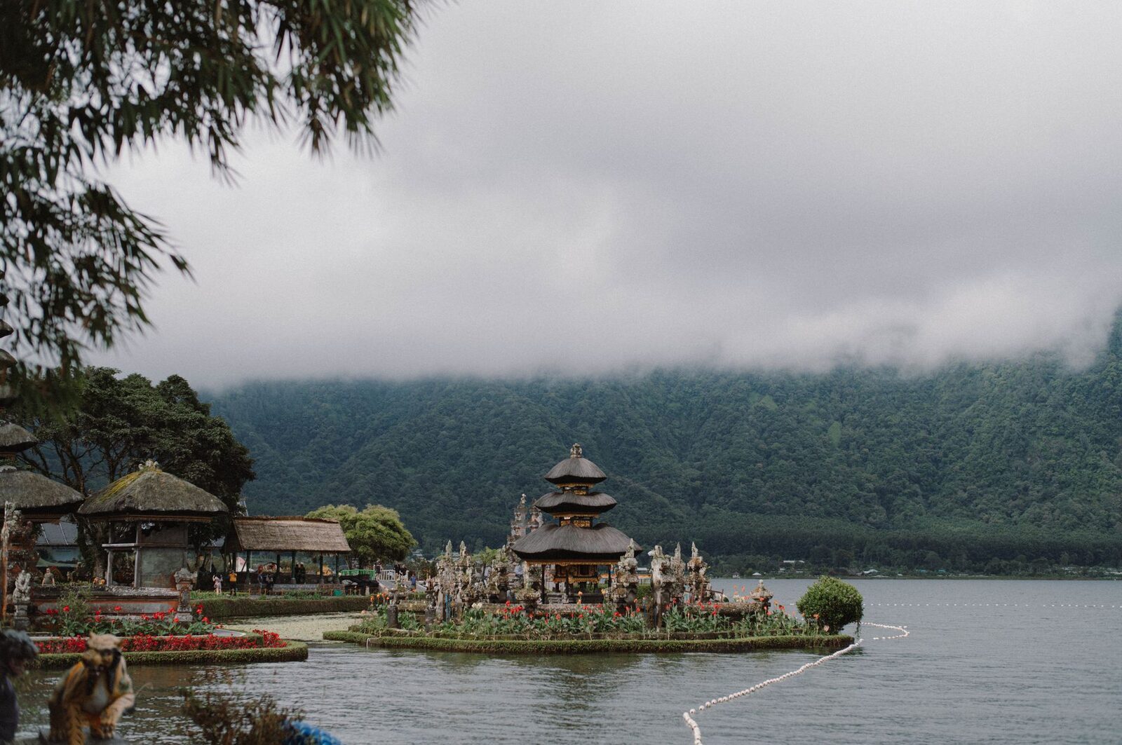 The temple complex small against the misty forested mountains that ring the lake.