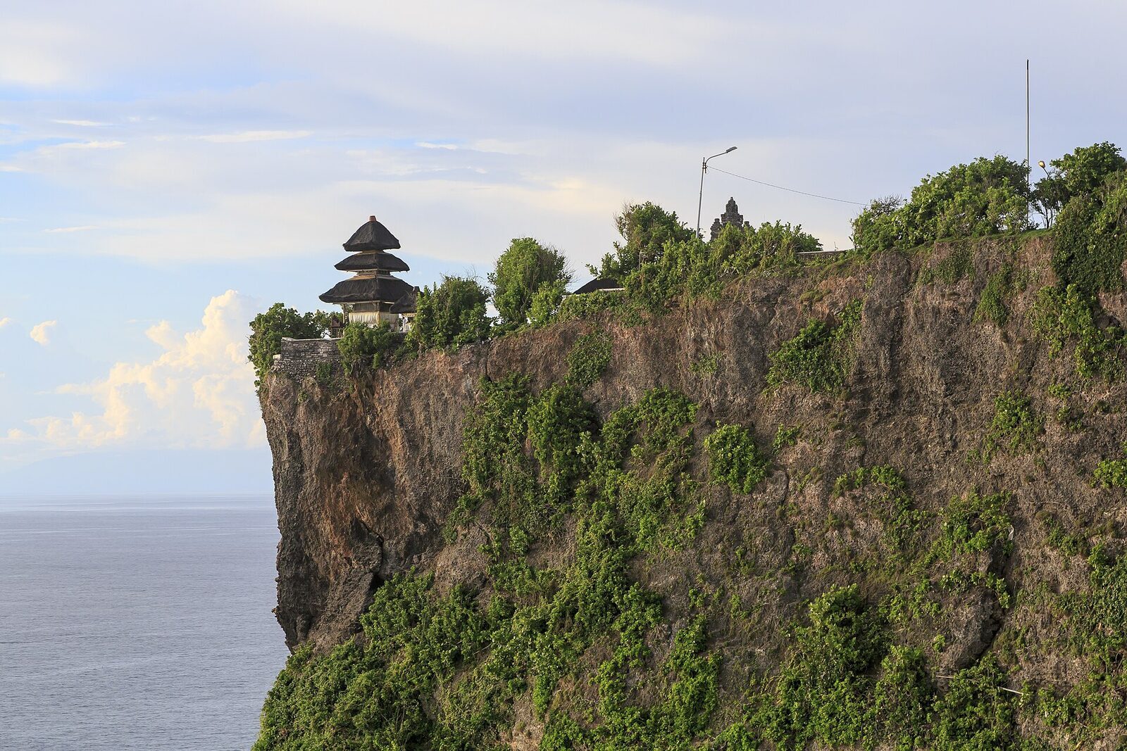 Pura Luhur Uluwatu — a single meru on the very lip of the headland, the Indian Ocean some 70 metres below.