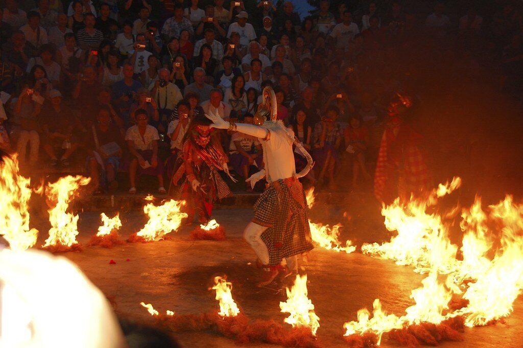 The fire finale: a performer treading through burning coconut husks — the sanghyang jaran trance, bolted on after the Ramayana.