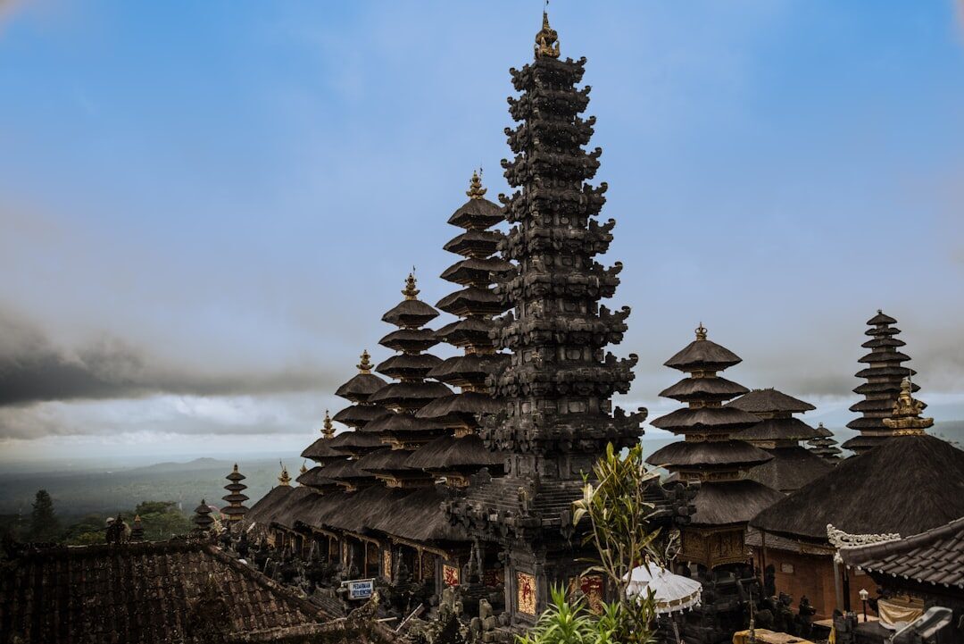 The black meru towers of Besakih in mist — the supreme eleven-tier shrines, far grander than Uluwatu's.