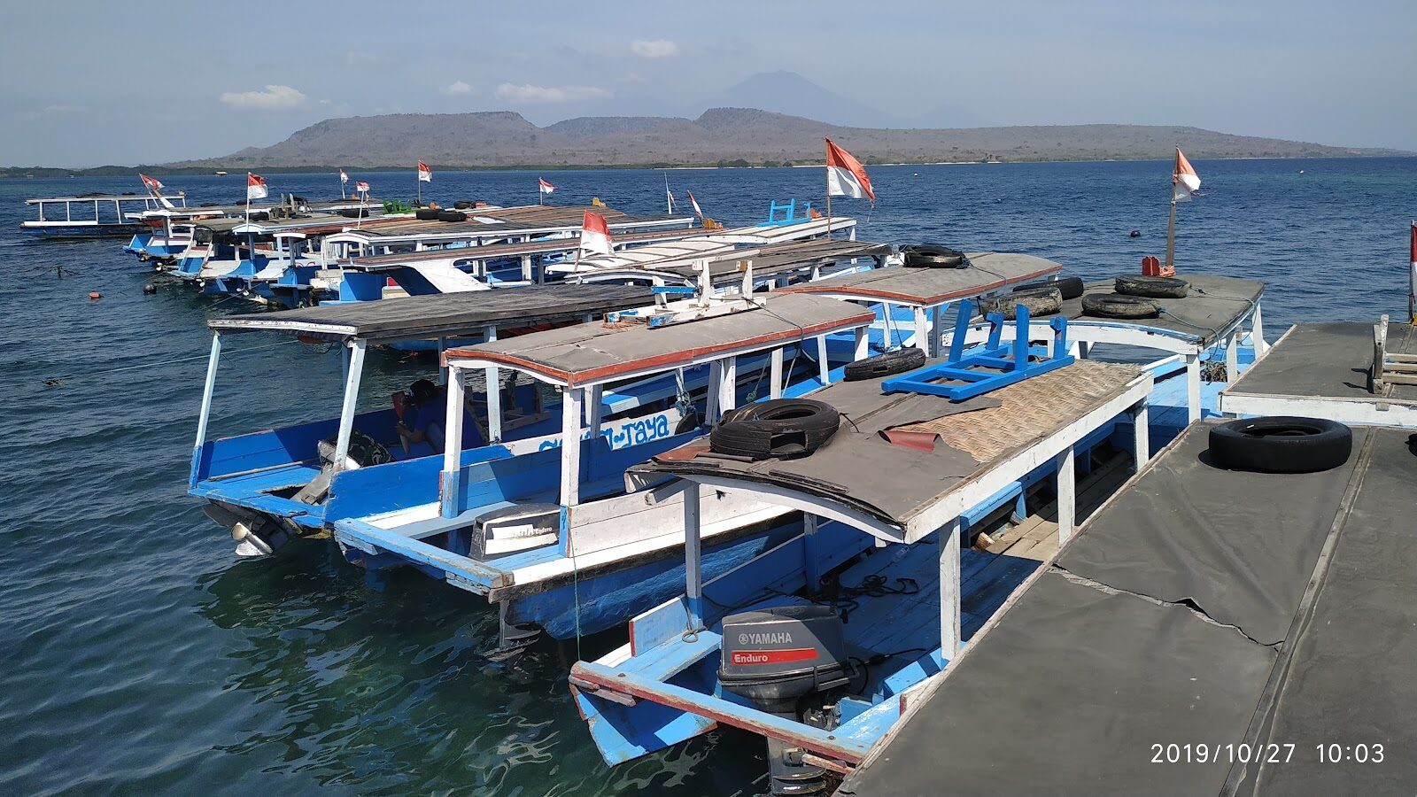 Boats at the Labuan Lalang dock, Java hazy across the strait.