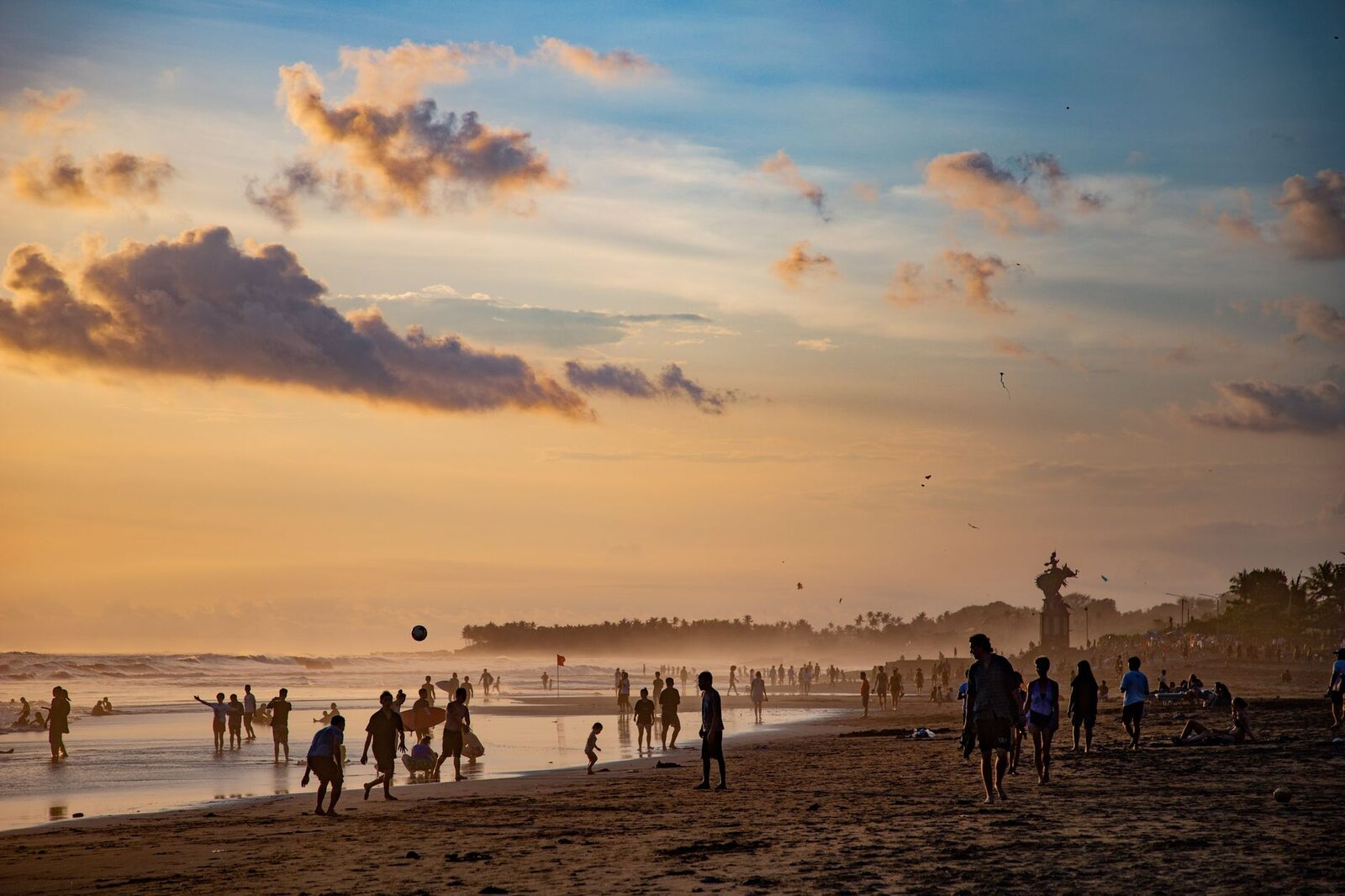 Silhouettes gathered on the sand for the Echo Beach sunset — busy, and part of the appeal.