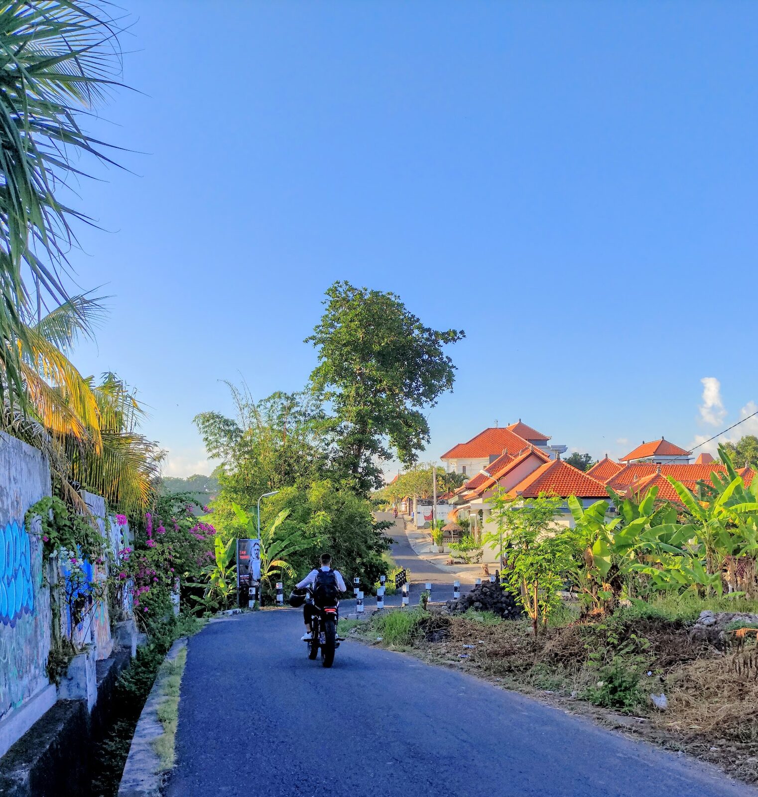 A scooter on a painted Canggu lane — the default way to get around, and often faster than a car in the jams.