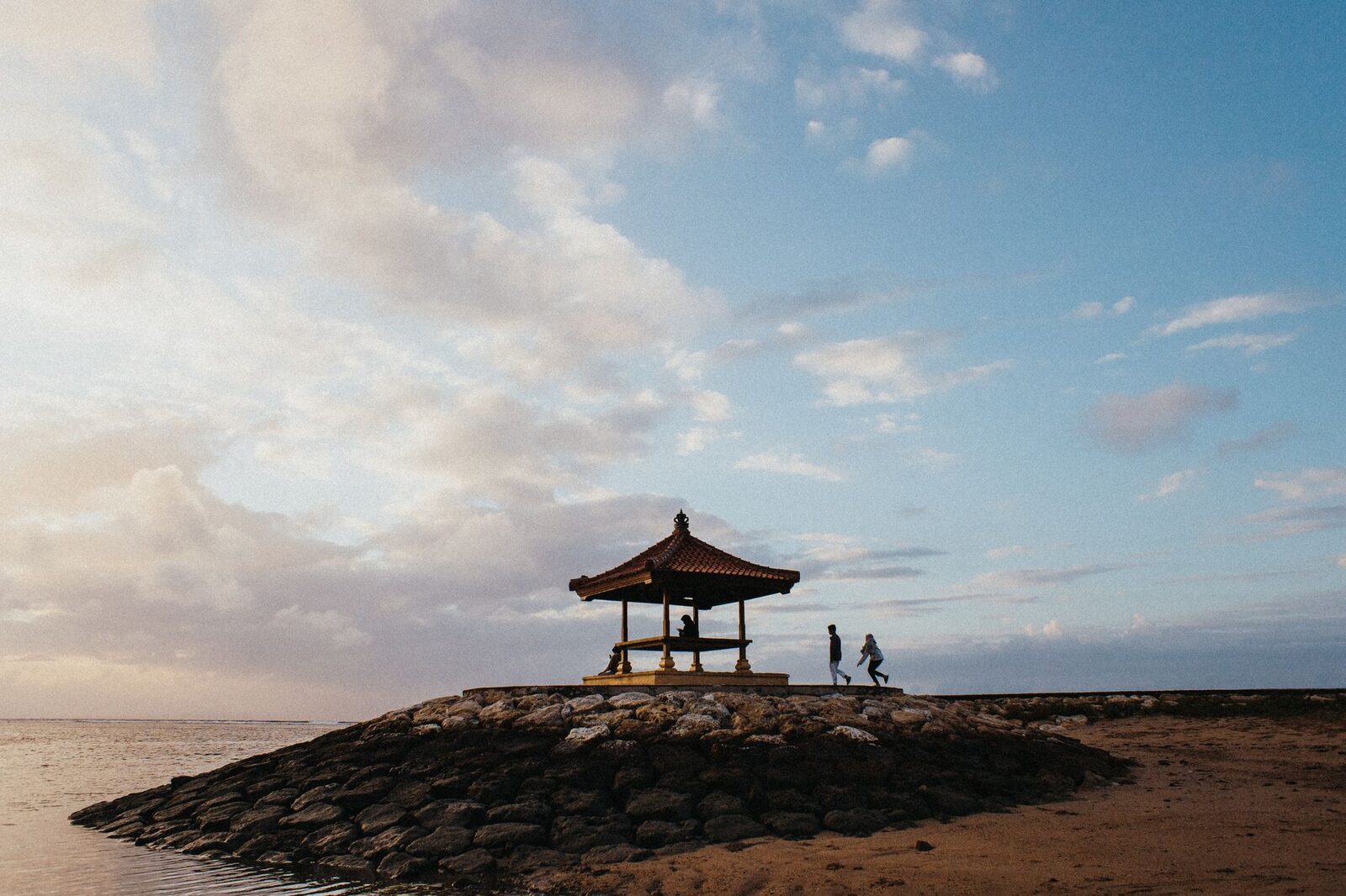 A stone bale on a breakwater over glassy water — the mellow, underrated east coast.