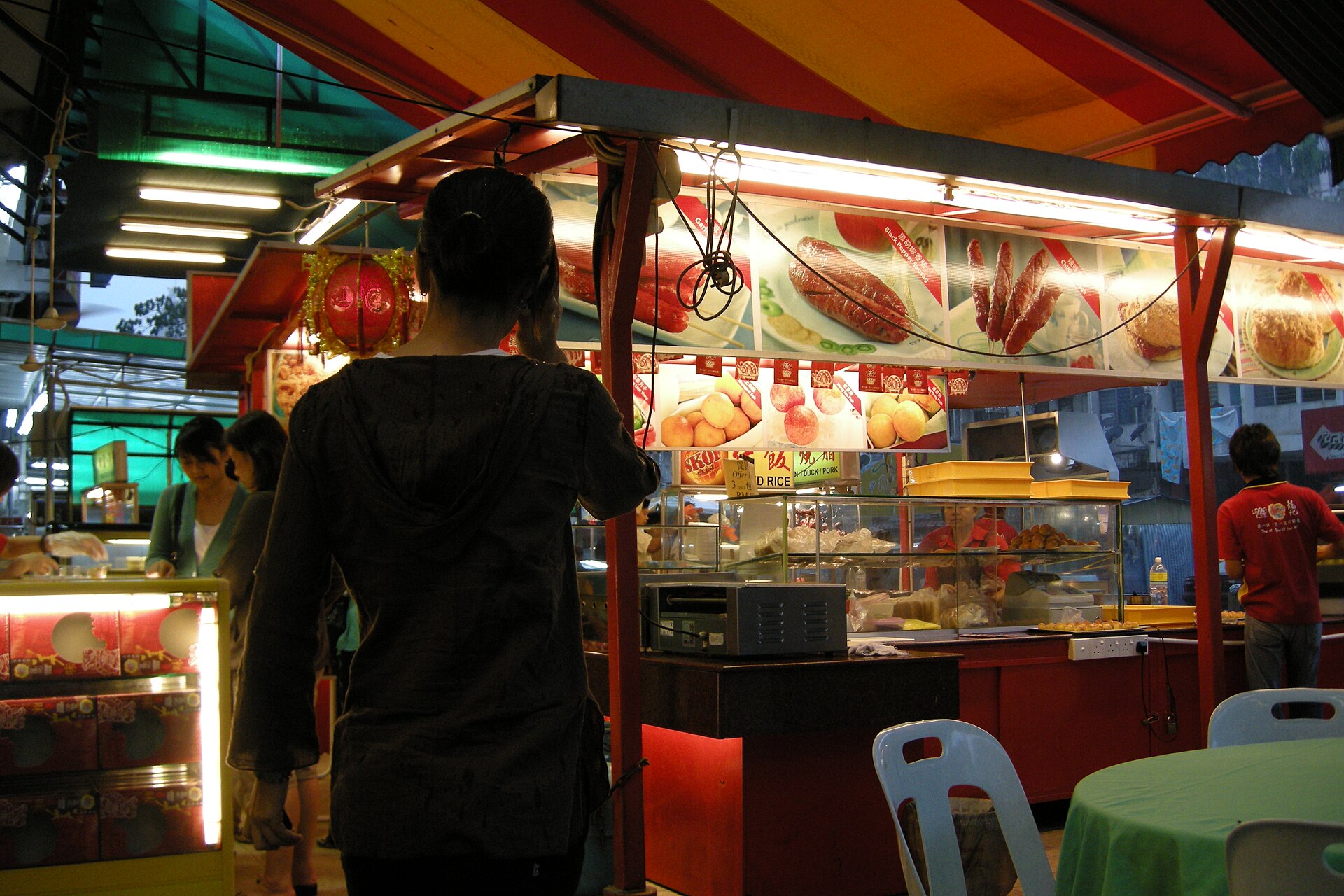 A lit food stall on a Bukit Bintang street at night.