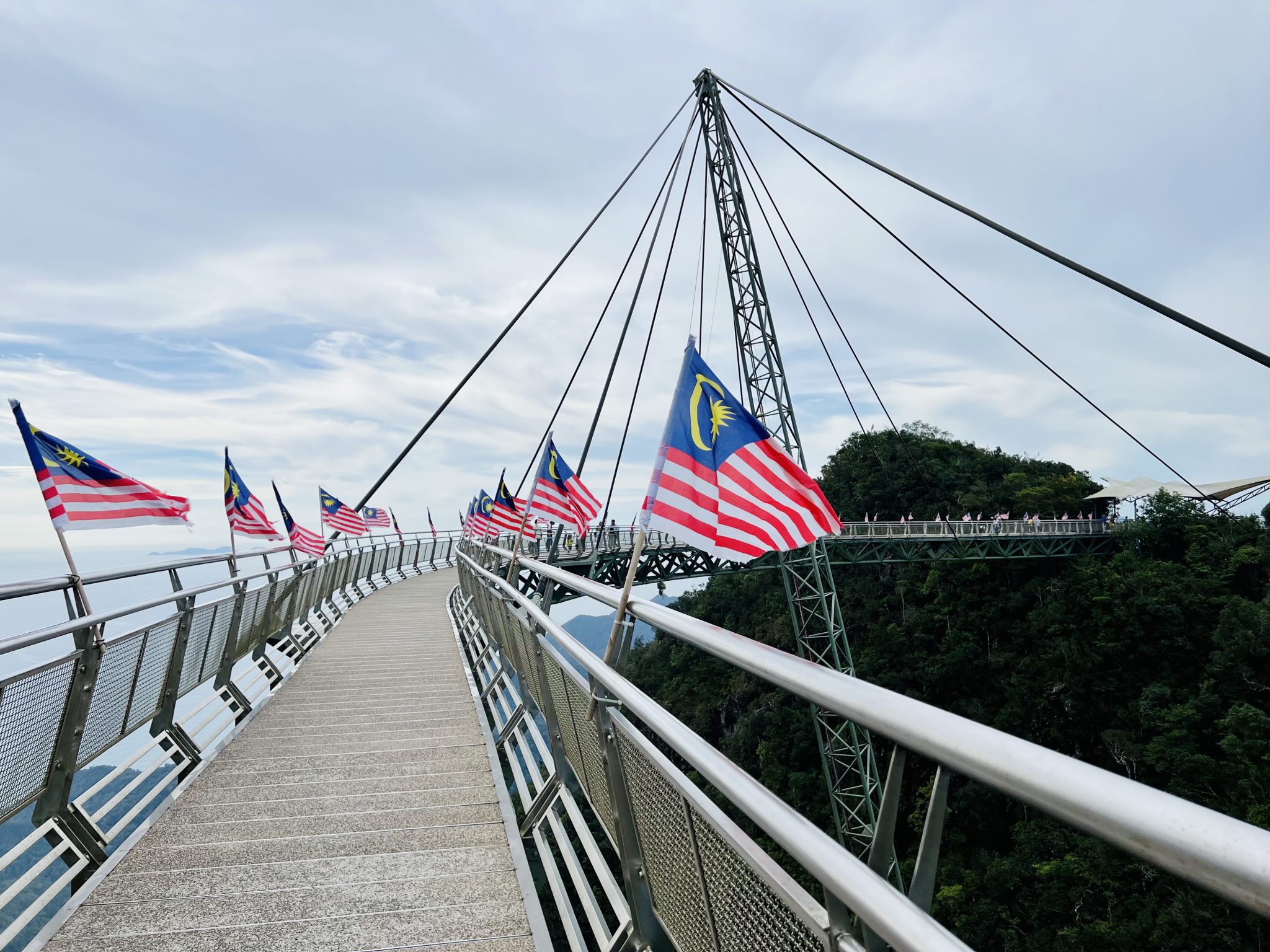 Malaysian flags lining the railing of the curved SkyBridge deck.