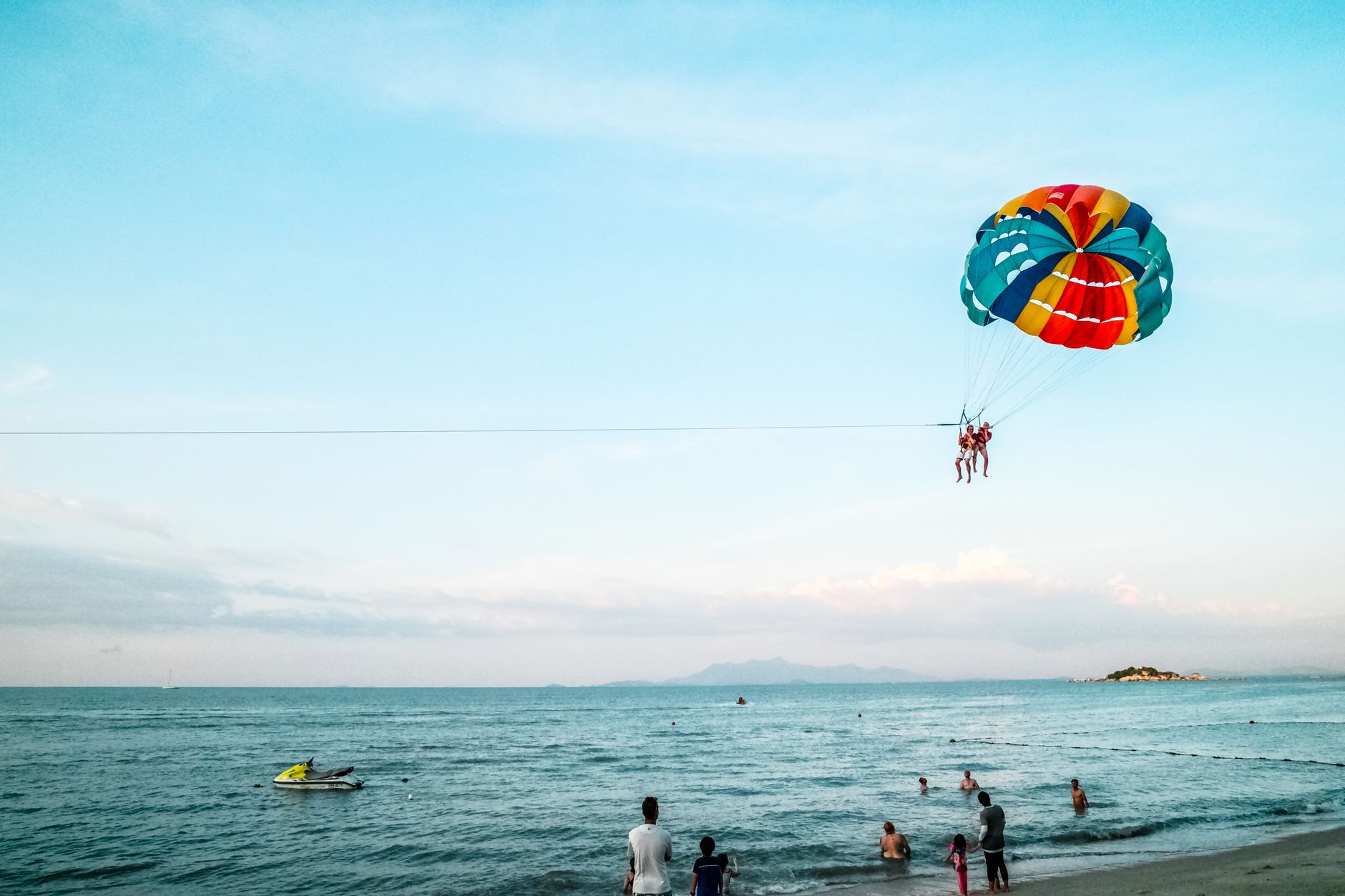 Parasailing over the turquoise water off Pantai Cenang.