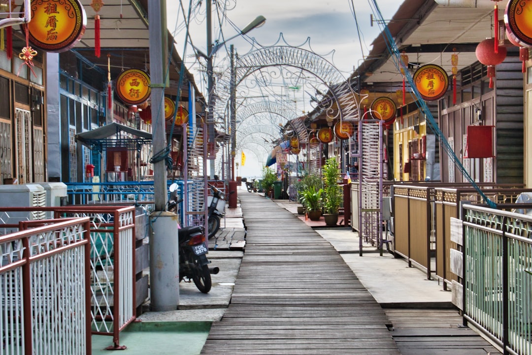 The Chew Jetty boardwalk, a stilt-house clan settlement in George Town, lanterns strung overhead.